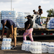 JACKSON, MS - AUGUST 31: Cases of bottled water are handed out at a Mississippi Rapid Response Coalition distribution site on August 31, 2022, in Jackson, Mississippi. Jackson is experiencing a third day without reliable water service after river flooding caused the main treatment facility to fail. Late Tuesday night, President Joe Biden declared an emergency amid the crisis.